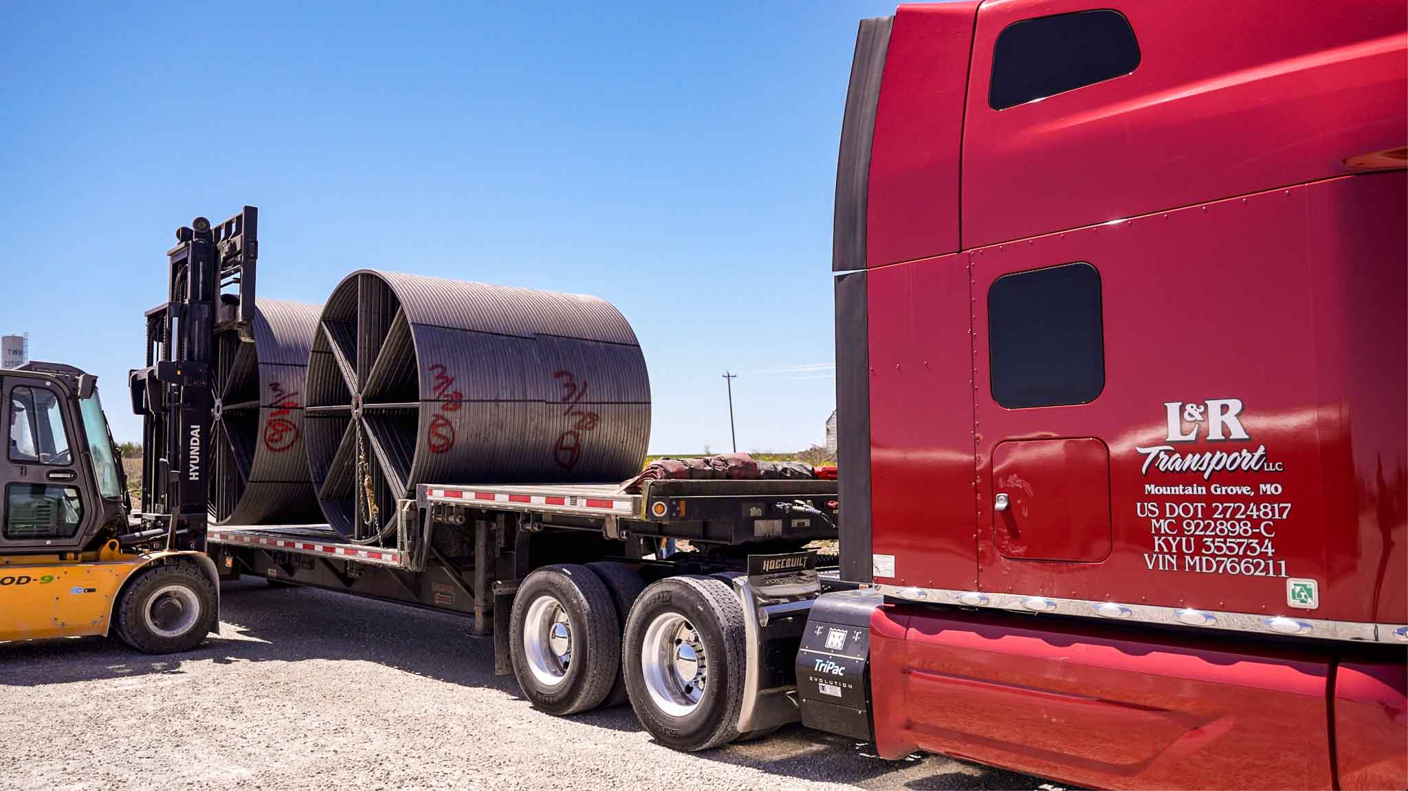 hauling steel reels on L&R Transport Peterbilt trucks